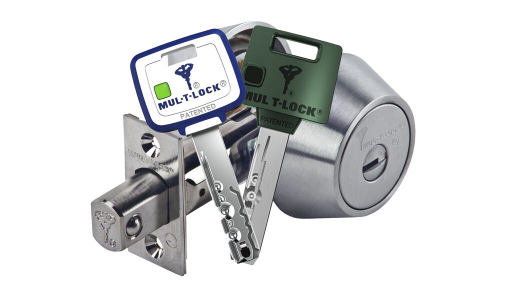 Mul-T-Lock high security deadbolt with two patented dimple keys in front of the cylinder and bolt