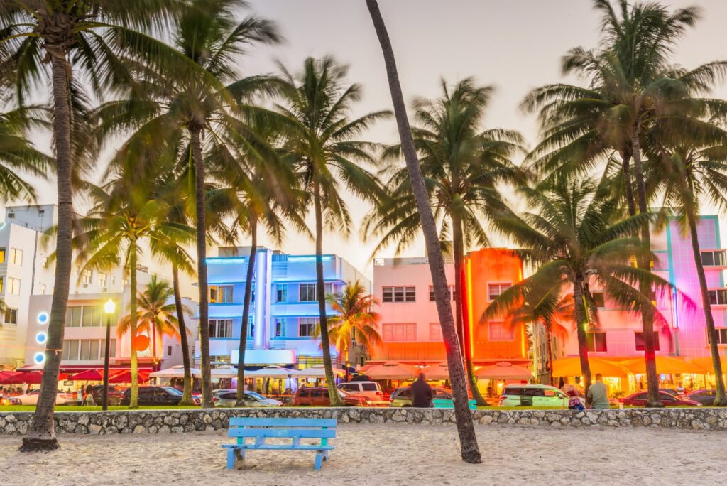 Art Deco hotels and palm trees along Ocean Drive in Miami Beach at dusk